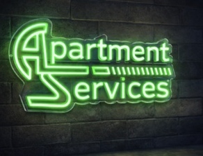 Green Apartment Services logo on a dark brick wall